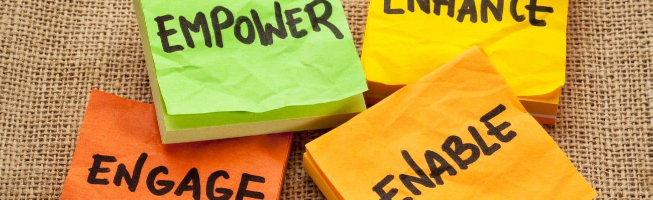 Image showing post-it notes in different colours with hand written words to include empower enhance engage and enable